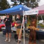 L to R: Dean Young selects the winning raffle ticket for the carved bear, Leon Austin, and the bear.