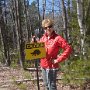 Judi Lindsey posts "Critter Crossing" signs at critical crossings areas.
