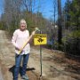 Barb Robidoux helps post critter crossing signs.
