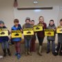 Club members paint the "Critter Crossing" signs to be put along Candia's roads this spring to help protect crossing animals
