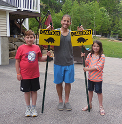 The Colotti family holding their Candia Conservation Commission critter crossing signs