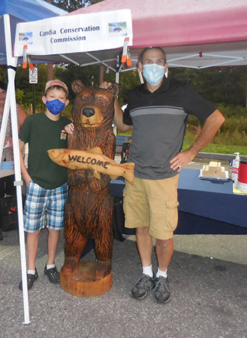 L to R: Remy Alff, the 2019 Barry Conservation Camp winner, the bear, and Leon Austin, the artist who carved the bear